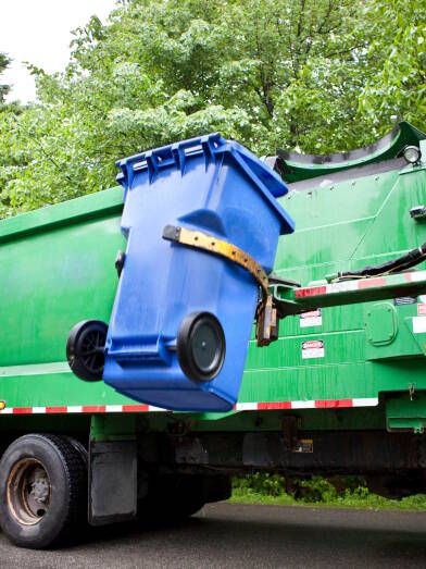 Recycling truck picking up bin