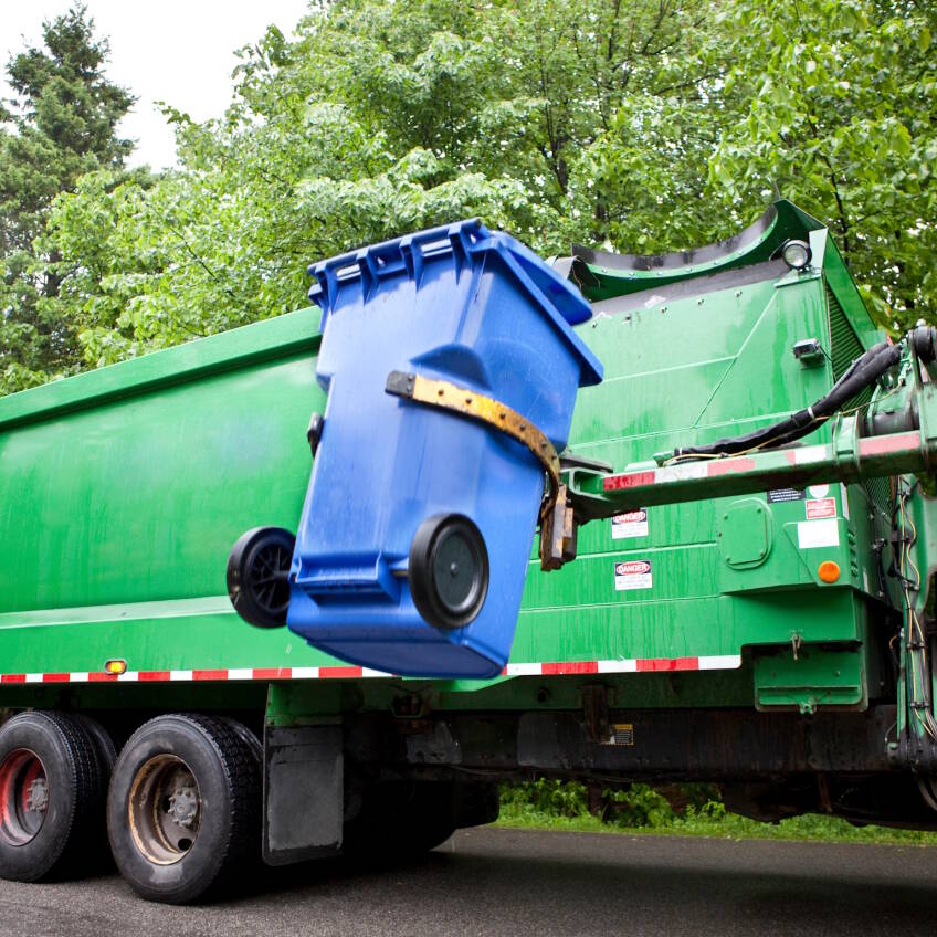 Recycling truck picking up bin